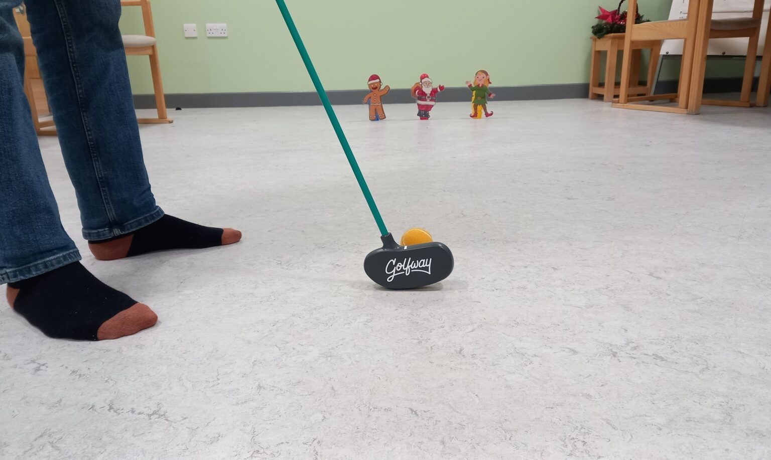 Person playing indoor golf