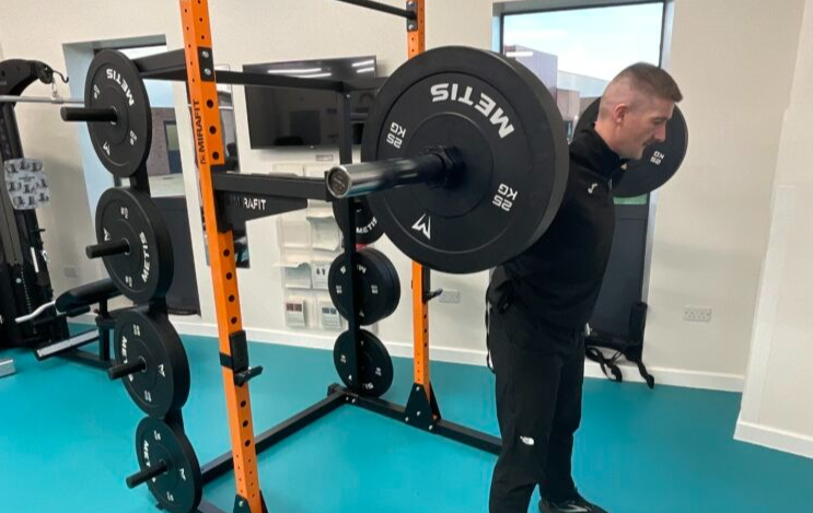 Man squatting using a barbell